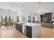 Open-concept kitchen with a large kitchen island, modern appliances, and an adjacent dining area at 4300 Bayshore Ne Blvd, St Petersburg, FL 33703