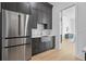 Modern kitchen with stainless steel refrigerator and a stainless farmhouse-style sink and gray cabinets at 4300 Bayshore Ne Blvd, St Petersburg, FL 33703