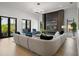 Bright living room featuring a modern fireplace, large windows and comfortable seating area at 4300 Bayshore Ne Blvd, St Petersburg, FL 33703