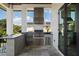 Outdoor grill area with stainless steel grill, prep space, and bar seating for entertaining at 4300 Bayshore Ne Blvd, St Petersburg, FL 33703