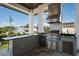 Modern outdoor kitchen featuring a stainless steel grill, beverage center, and countertop, perfect for entertaining guests at 4300 Bayshore Ne Blvd, St Petersburg, FL 33703