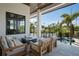 Outdoor seating on a covered patio overlooking a private pool and tropical landscaping at 4300 Bayshore Ne Blvd, St Petersburg, FL 33703