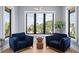 A bright sitting room features two armchairs, a modern side table, and expansive windows at 4300 Bayshore Ne Blvd, St Petersburg, FL 33703