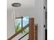 Staircase window provides natural light and neighborhood views, accentuating the modern railing design at 4300 Bayshore Ne Blvd, St Petersburg, FL 33703