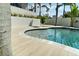 Modern backyard pool with travertine tile deck and minimal landscaping, offering a serene retreat at 4300 Bayshore Ne Blvd, St Petersburg, FL 33703