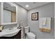Bathroom featuring a traditional vanity, toilet and framed mirror at 4709 Puritan Cir # 702, Tampa, FL 33617