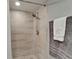 Bathroom shower featuring stylish tiling, modern showerhead and soft grey walls at 4709 Puritan Cir # 702, Tampa, FL 33617