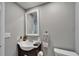 Bathroom featuring a traditional vanity, toilet and framed mirror at 4709 Puritan Cir # 702, Tampa, FL 33617