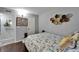 Well-lit bedroom with hardwood floors, decorative wall art, and a comfortable queen-size bed at 4709 Puritan Cir # 702, Tampa, FL 33617