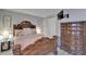 Comfortable bedroom boasts an ornate bed frame, wood plank floors, and decorative lamps and furnishings at 4709 Puritan Cir # 702, Tampa, FL 33617
