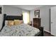 Comfortable bedroom features a queen-size bed, hardwood floors, and window providing natural light at 4709 Puritan Cir # 702, Tampa, FL 33617