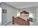Cozy bedroom features an ornate bed frame, wood plank floors, and sliding door closet at 4709 Puritan Cir # 702, Tampa, FL 33617