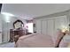A relaxing bedroom featuring a large dresser and a plush bed with soft pink bedding at 4709 Puritan Cir # 702, Tampa, FL 33617