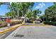 Gated community entrance with security gate and mature landscaping at 4709 Puritan Cir # 702, Tampa, FL 33617