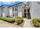 Inviting condo with well-maintained landscaping and exterior stairs to upper level at 4709 Puritan Cir # 702, Tampa, FL 33617