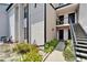 Building exterior featuring well-maintained landscaping and access stairs to upper-level units at 4709 Puritan Cir # 702, Tampa, FL 33617