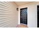 Front exterior of a home with a classic black door, sidelight and brick entryway at 4709 Puritan Cir # 702, Tampa, FL 33617