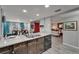 Well-lit kitchen featuring granite counters, stainless steel appliances, and a view into an adjacent living area at 4709 Puritan Cir # 702, Tampa, FL 33617