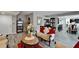 A living room with a white sofa set, gray walls, gray wood floors, red curtains, and a marble table at 4709 Puritan Cir # 702, Tampa, FL 33617