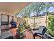 Inviting patio area with lush landscaping, a grill, and comfortable seating arrangement at 4709 Puritan Cir # 702, Tampa, FL 33617