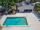 Aerial view of rectangular community pool with lounge chairs and adjacent covered area and mature landscaping at 4709 Puritan Cir # 702, Tampa, FL 33617