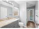 Bright bathroom with granite vanity, wood flooring, and a glass door to the pool area at 4761 Stoneview Cir, Oldsmar, FL 34677