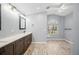 Bathroom featuring double vanity, and a large window at 4761 Stoneview Cir, Oldsmar, FL 34677