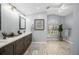 Bathroom featuring double vanity, and a large window at 4761 Stoneview Cir, Oldsmar, FL 34677
