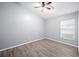 Bedroom featuring a ceiling fan, a window, and updated flooring at 4761 Stoneview Cir, Oldsmar, FL 34677
