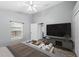Stylized bedroom featuring ceiling fan, a TV, and updated decor at 4761 Stoneview Cir, Oldsmar, FL 34677