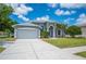 Charming house with a large garage, driveway, and well-manicured front yard at 4761 Stoneview Cir, Oldsmar, FL 34677
