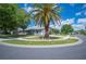 Landscaped front yard with mature trees, sidewalks, and well maintained lawn at 4761 Stoneview Cir, Oldsmar, FL 34677