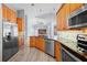 Updated kitchen featuring stainless appliances, modern cabinets, granite counters, and wood-look floors at 4761 Stoneview Cir, Oldsmar, FL 34677