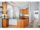 Open concept kitchen featuring an island, lots of cabinets and counterspace, and wood-look flooring at 4761 Stoneview Cir, Oldsmar, FL 34677