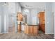 Open kitchen with island seating, lots of cabinet space, stainless appliances, and modern lighting at 4761 Stoneview Cir, Oldsmar, FL 34677