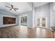 Bright living room featuring vaulted ceilings, recessed lighting, and access to the outdoor pool area at 4761 Stoneview Cir, Oldsmar, FL 34677