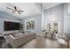 Open-concept living room featuring high ceilings, modern decor, a ceiling fan, and lots of natural light at 4761 Stoneview Cir, Oldsmar, FL 34677