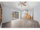Open living space with tile flooring, large sliding doors, and kitchen in the background at 4761 Stoneview Cir, Oldsmar, FL 34677