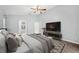 Main bedroom with vaulted ceiling, TV, and arched doorway to the ensuite bathroom at 4761 Stoneview Cir, Oldsmar, FL 34677