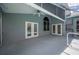 Screened in patio area with ceiling fan and dual French doors overlooking the pool at 4761 Stoneview Cir, Oldsmar, FL 34677