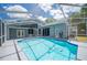 A beautiful in-ground pool featuring a screened enclosure with a covered lanai at 4761 Stoneview Cir, Oldsmar, FL 34677