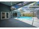 A serene view of the backyard pool with a screened lanai, perfect for relaxation at 4761 Stoneview Cir, Oldsmar, FL 34677