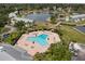 Aerial shot of the community pool surrounded by lounge chairs and lush landscaping, offering a relaxing retreat at 4858 Coquina Key Se Dr # C, St Petersburg, FL 33705