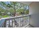 Balcony with a street view of trees, homes, and parked cars across the street at 5115 S Jules Verne Ct, Tampa, FL 33611