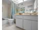 Bright bathroom featuring a tub with shower and white vanity with neutral countertop at 5115 S Jules Verne Ct, Tampa, FL 33611