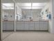Bathroom featuring a large mirror, dual sinks, and ample cabinet space at 5115 S Jules Verne Ct, Tampa, FL 33611