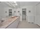 Bathroom with a long vanity with dual sinks, marble countertop and an open entry to shower and toilet at 5115 S Jules Verne Ct, Tampa, FL 33611