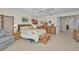 Spacious bedroom featuring neutral walls, plush carpet, and a seating area at 5115 S Jules Verne Ct, Tampa, FL 33611