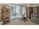 Bedroom featuring a ceiling fan, a large bed, sliding glass doors and a dressing table at 5115 S Jules Verne Ct, Tampa, FL 33611