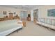 Spacious bedroom featuring neutral walls, plush carpet, and a seating area at 5115 S Jules Verne Ct, Tampa, FL 33611